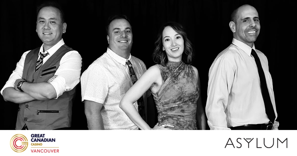 Four people stand smiling in a row against a black background. The image is in black and white. Logos for Great Canadian Casino Vancouver and ASYLUM are at the bottom.