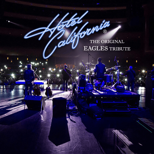 A band performs on a dimly lit stage before an audience holding up glowing mobiles, with "Hotel California: The Original Eagles Tribute" written in bright blue and white text above them.